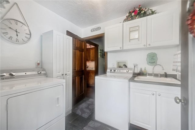 227 Holly Pl, Mount Pleasant Twp Wml, PA 15666 - laundry room featuring washer and clothes dryer, cabinet space, dark tile patterned floors, and a textured ceiling