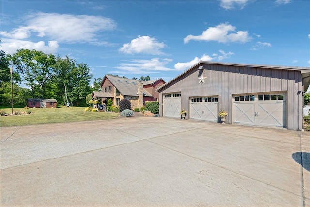 227 Holly Pl, Mount Pleasant Twp Wml, PA 15666 - view of front of home with a garage, an outbuilding, and a front lawn