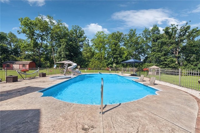 227 Holly Pl, Mount Pleasant Twp Wml, PA 15666 - view of pool with a water slide, a patio area, and view of wooded area