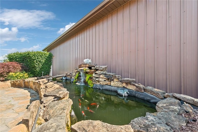 227 Holly Pl, Mount Pleasant Twp Wml, PA 15666 - view of home's exterior featuring a small pond