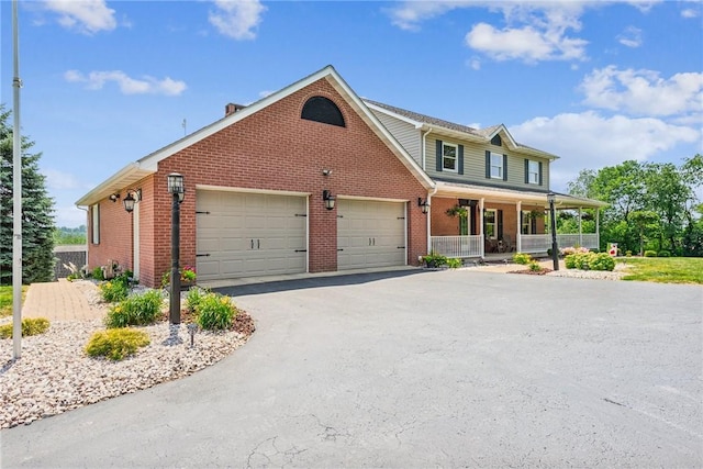 401 Pittsburgh St, Derry Twp, PA 15671 - view of front facade featuring a porch, brick siding, an attached garage, and driveway