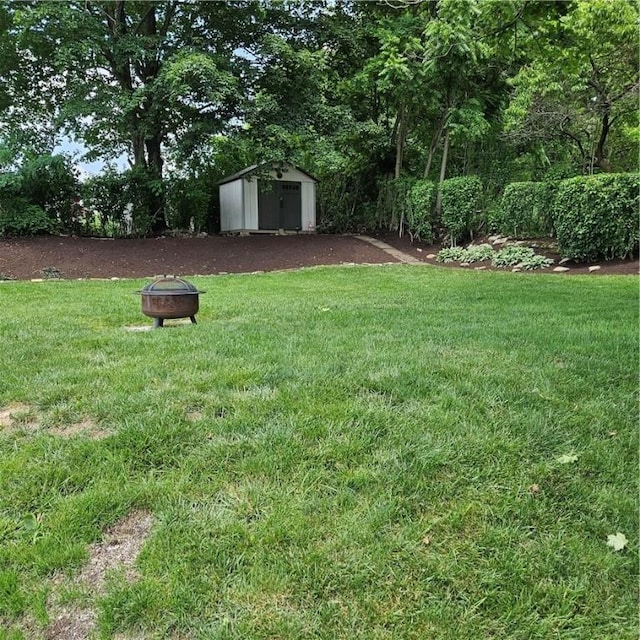 3381 Columbia Dr, Castle Shannon, PA 15234 - view of green lawn featuring a fire pit and a storage unit