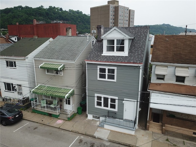 16 4th St, Sharpsburg, PA 15215 - rear view of property with roof with shingles, a chimney, and uncovered parking