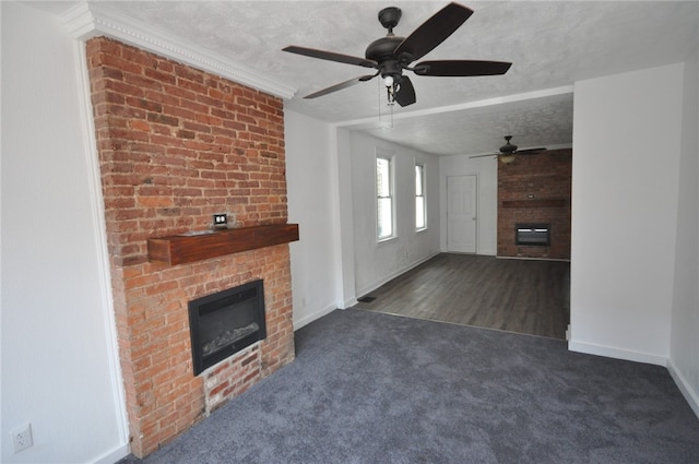 16 4th St, Sharpsburg, PA 15215 - unfurnished living room featuring a brick fireplace, carpet flooring, a ceiling fan, and a textured ceiling