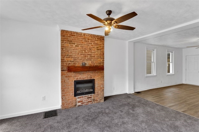 16 4th St, Sharpsburg, PA 15215 - unfurnished living room with a ceiling fan, a brick fireplace, and carpet