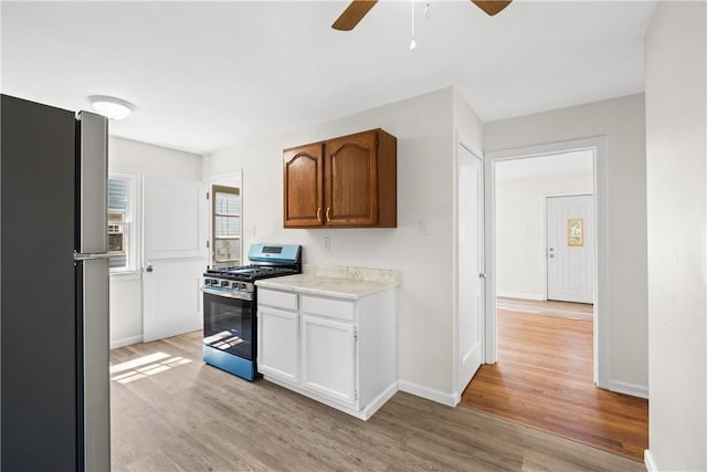 125 Carroll St, Aliquippa, PA 15001 - kitchen with appliances with stainless steel finishes, light wood-type flooring, ceiling fan, and light countertops