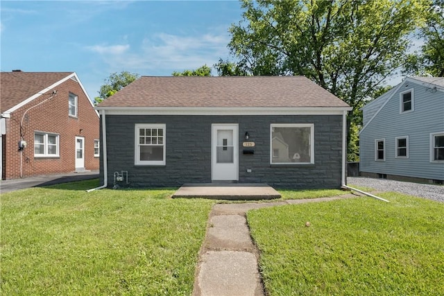 125 Carroll St, Aliquippa, PA 15001 - bungalow-style home with stone siding, a front lawn, and a shingled roof