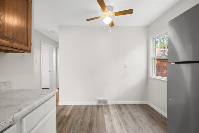 125 Carroll St, Aliquippa, PA 15001 - unfurnished dining area with light wood-style floors and ceiling fan
