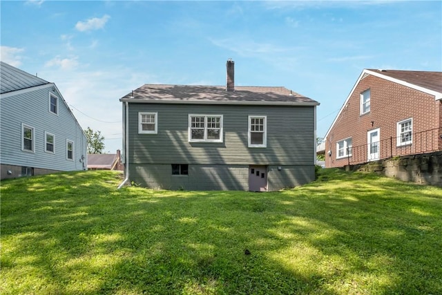 125 Carroll St, Aliquippa, PA 15001 - back of property with a lawn, a chimney, and a shingled roof