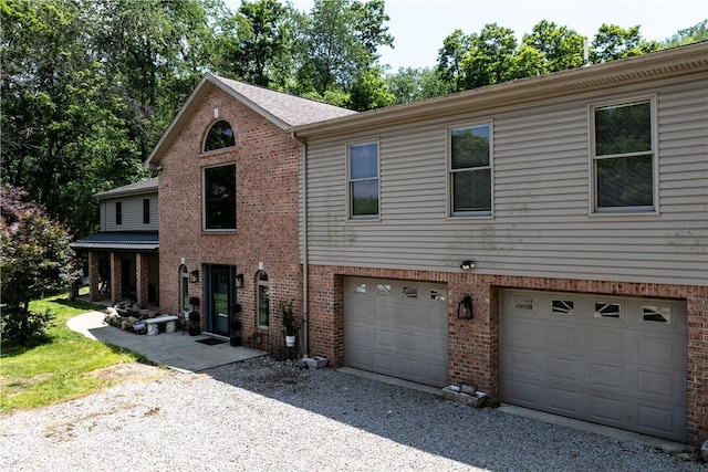 207 Linden Rd, North Strabane, PA 15317 - view of front of house with a garage, gravel driveway, and brick siding
