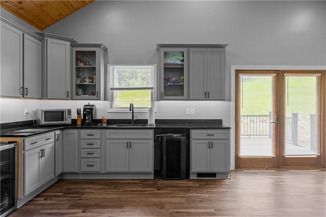 207 Linden Rd, North Strabane, PA 15317 - kitchen with gray cabinets, stainless steel microwave, lofted ceiling, beverage cooler, and dark countertops