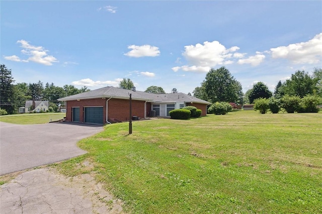 410 Blackhawk Rd, Chippewa Twp, PA 15010 - view of front of property featuring asphalt driveway, a garage, brick siding, and a front yard