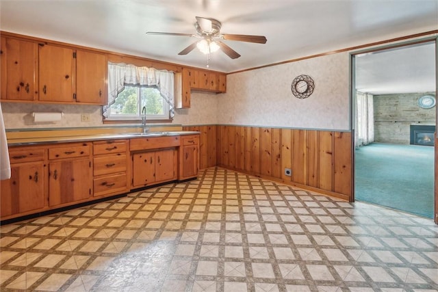 410 Blackhawk Rd, Chippewa Twp, PA 15010 - kitchen with a wainscoted wall, ceiling fan, light countertops, light flooring, and brown cabinets