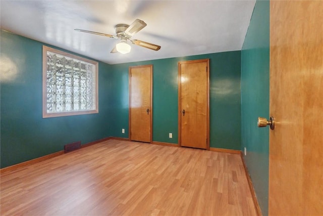 410 Blackhawk Rd, Chippewa Twp, PA 15010 - unfurnished bedroom with light wood finished floors, multiple closets, and a ceiling fan