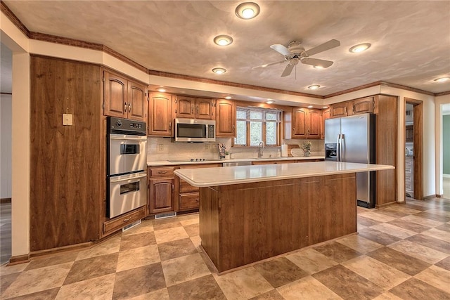 1318 Dellview Dr, Unity Twp, PA 15601 - kitchen featuring stainless steel appliances, crown molding, light countertops, a kitchen island, and ceiling fan