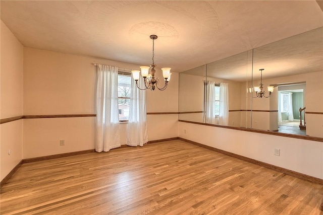 1318 Dellview Dr, Unity Twp, PA 15601 - unfurnished dining area featuring a chandelier and wood finished floors