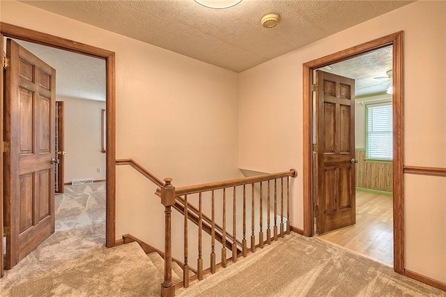 1318 Dellview Dr, Unity Twp, PA 15601 - hallway featuring an upstairs landing, light carpet, and a textured ceiling