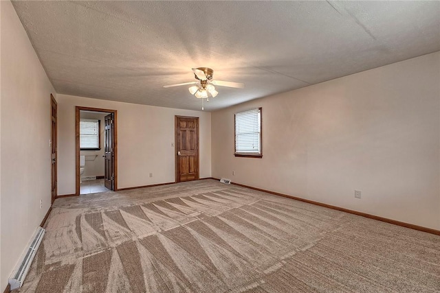 1318 Dellview Dr, Unity Twp, PA 15601 - unfurnished bedroom featuring baseboard heating, light carpet, ensuite bath, a textured ceiling, and ceiling fan