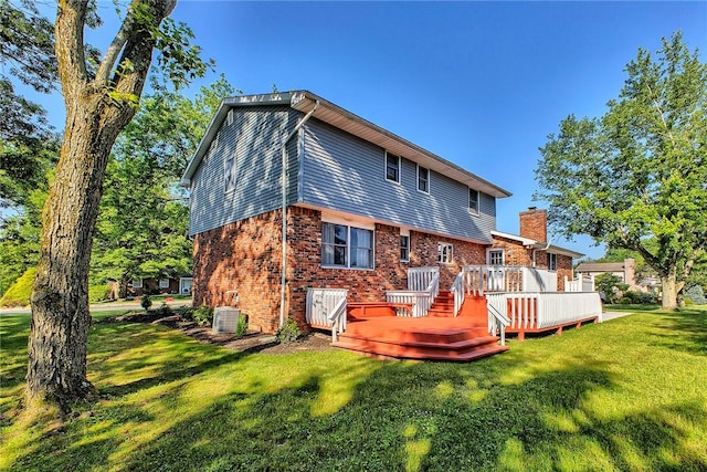1318 Dellview Dr, Unity Twp, PA 15601 - rear view of property with a yard, brick siding, a deck, and a chimney