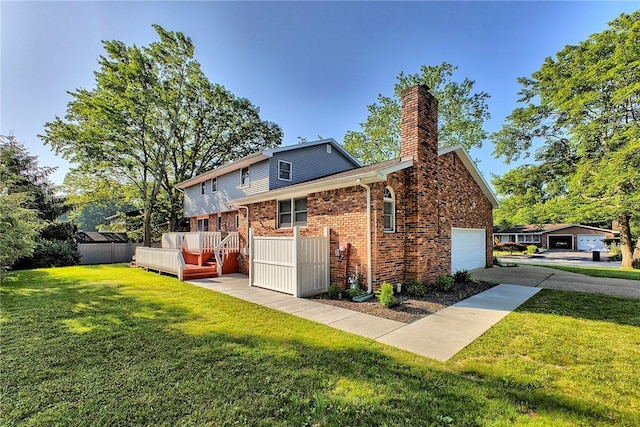 1318 Dellview Dr, Unity Twp, PA 15601 - rear view of house with a garage, a chimney, a lawn, a deck, and brick siding