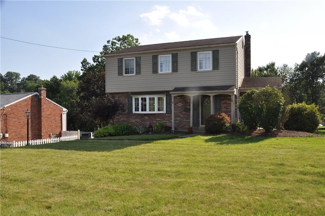 5676 Marilynn Dr, Bethel Park, PA 15236 - view of front of home with a front lawn, a chimney, and brick siding