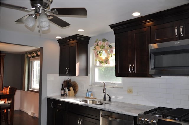 5676 Marilynn Dr, Bethel Park, PA 15236 - kitchen with appliances with stainless steel finishes, tasteful backsplash, light stone counters, ceiling fan, and recessed lighting