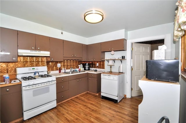 3411 York St, Mckeesport, PA 15132 - kitchen with white appliances, under cabinet range hood, wood finished floors, tasteful backsplash, and open shelves