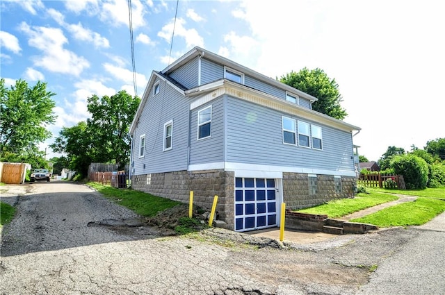 3411 York St, Mckeesport, PA 15132 - view of home's exterior featuring a garage and asphalt driveway