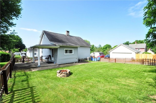 3411 York St, Mckeesport, PA 15132 - rear view of house with an outdoor fire pit, a fenced backyard, and a patio