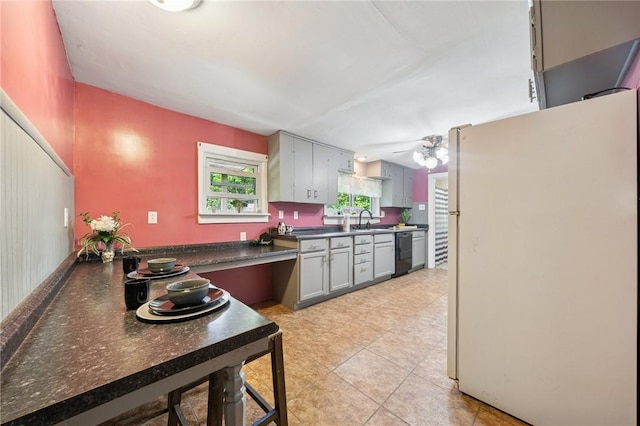 665 Stuchell Rd, Burrel/Blacklick, PA 15748 - kitchen featuring freestanding refrigerator, dark countertops, dishwasher, light tile patterned flooring, and gray cabinets