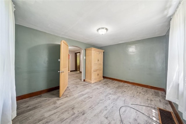 665 Stuchell Rd, Burrel/Blacklick, PA 15748 - empty room with arched walkways and light wood-type flooring