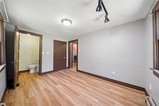 665 Stuchell Rd, Burrel/Blacklick, PA 15748 - unfurnished bedroom with light wood finished floors, a baseboard radiator, and ensuite bath
