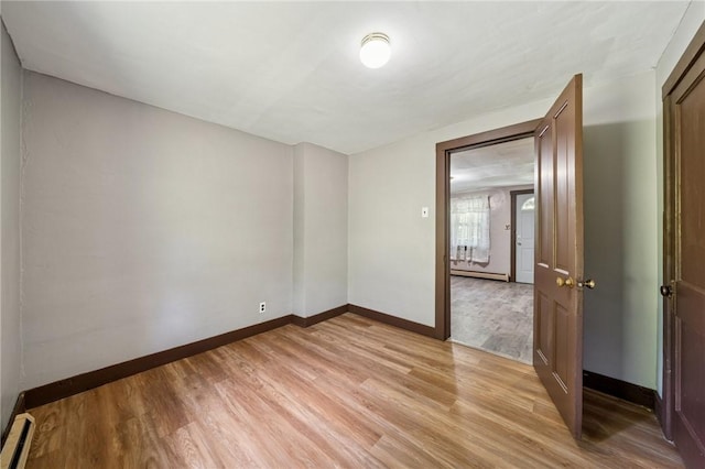 665 Stuchell Rd, Burrel/Blacklick, PA 15748 - empty room featuring light wood-style floors, a baseboard radiator, and a baseboard heating unit