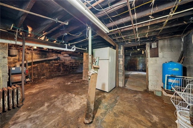 665 Stuchell Rd, Burrel/Blacklick, PA 15748 - unfinished below grade area featuring freestanding refrigerator and a water pressure tank