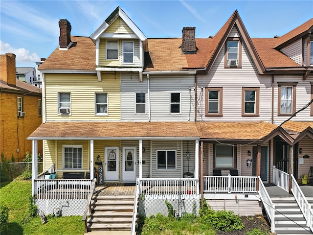 227 Henderson St, Fineview, PA 15212 - townhome / multi-family property with covered porch, a chimney, a shingled roof, stairs, and cooling unit