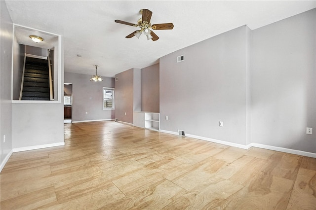 227 Henderson St, Fineview, PA 15212 - unfurnished living room with ceiling fan, wood finished floors, stairway, and a chandelier