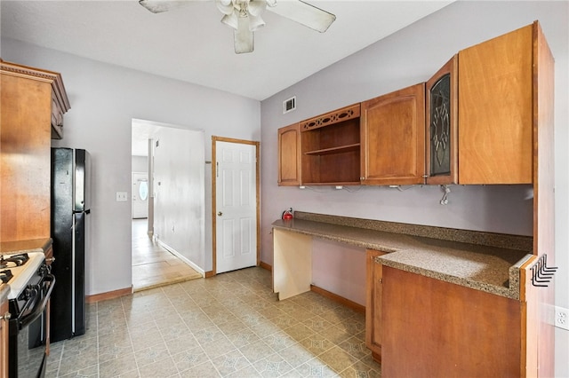 227 Henderson St, Fineview, PA 15212 - kitchen featuring range with gas cooktop, brown cabinets, ceiling fan, washer / dryer, and freestanding refrigerator