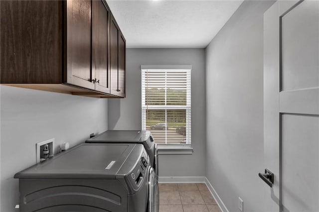 212 Bengal Fox, Jackson Twp, PA 16063 - laundry room with cabinet space, washer and dryer, and light tile patterned floors