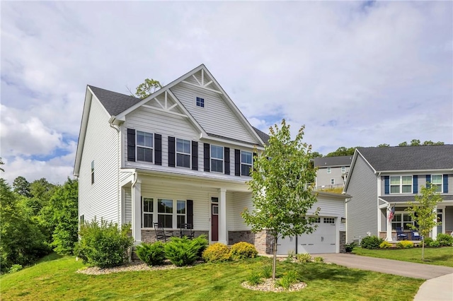212 Bengal Fox, Jackson Twp, PA 16063 - craftsman-style home with driveway, stone siding, and a front yard