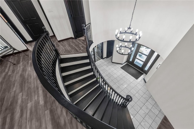 2460 Nicholson Rd, Franklin Park, PA 15143 - stairway featuring a chandelier, arched walkways, and wood finished floors