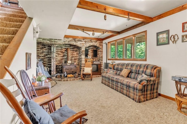 530 Perry Hwy, Lancaster Twp, PA 16037 - carpeted living room featuring a wood stove, beamed ceiling, and brick wall