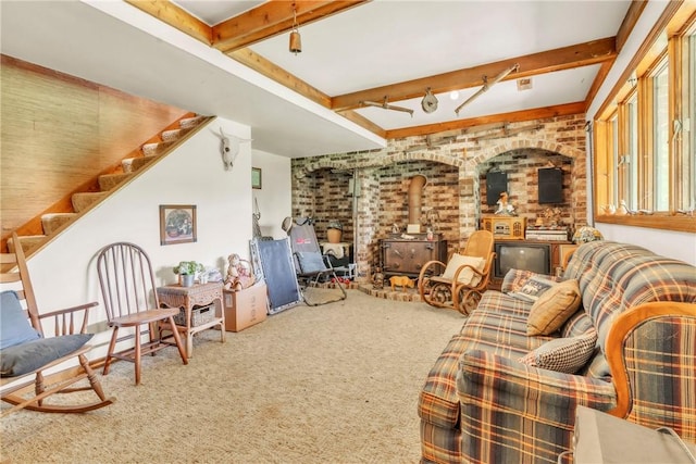 530 Perry Hwy, Lancaster Twp, PA 16037 - living room featuring a wood stove, carpet flooring, brick wall, beamed ceiling, and stairs