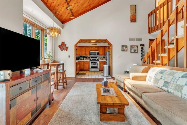 530 Perry Hwy, Lancaster Twp, PA 16037 - living area with wood ceiling, high vaulted ceiling, arched walkways, a chandelier, and light wood-type flooring