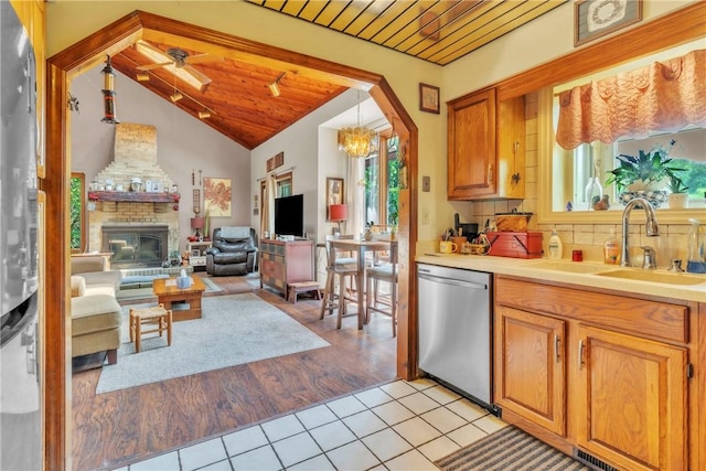 530 Perry Hwy, Lancaster Twp, PA 16037 - kitchen featuring stainless steel dishwasher, healthy amount of natural light, vaulted ceiling, light tile patterned floors, and a chandelier
