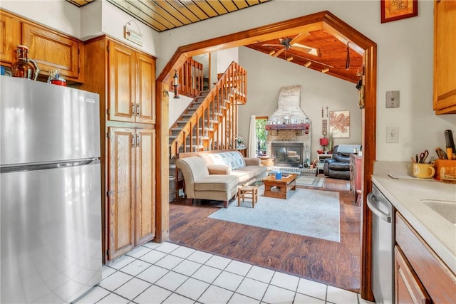 530 Perry Hwy, Lancaster Twp, PA 16037 - kitchen with stainless steel appliances, a brick fireplace, open floor plan, light tile patterned floors, and a ceiling fan