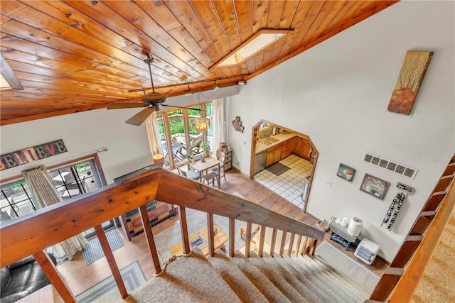 530 Perry Hwy, Lancaster Twp, PA 16037 - stairway featuring wooden ceiling, a ceiling fan, a skylight, lofted ceiling, and carpet flooring