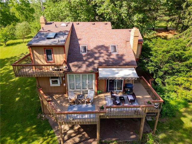 530 Perry Hwy, Lancaster Twp, PA 16037 - rear view of house featuring a chimney, a deck, a lawn, and outdoor dining space