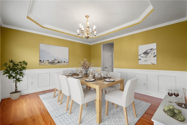 6412 Interlaken Dr, South Fayette, PA 15057 - dining area with a chandelier, wood finished floors, a raised ceiling, wainscoting, and crown molding