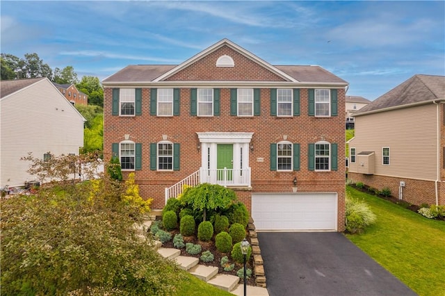 6412 Interlaken Dr, South Fayette, PA 15057 - view of front of home featuring brick siding, an attached garage, driveway, and a front lawn