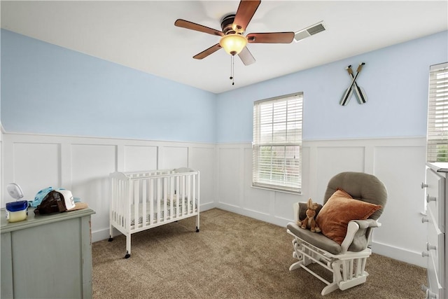 6412 Interlaken Dr, South Fayette, PA 15057 - carpeted bedroom featuring a decorative wall, wainscoting, a nursery area, and a ceiling fan
